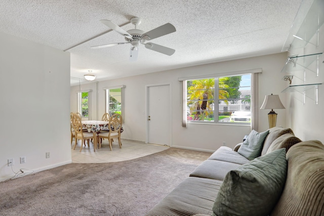 carpeted living room featuring ceiling fan, a healthy amount of sunlight, and a textured ceiling