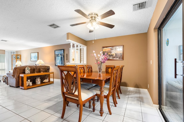 dining space featuring french doors, a textured ceiling, ceiling fan, and light tile patterned flooring