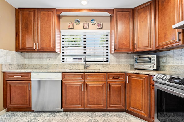 kitchen featuring sink, light tile patterned floors, light stone countertops, appliances with stainless steel finishes, and tasteful backsplash