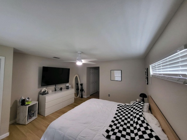 bedroom with ceiling fan and light hardwood / wood-style flooring