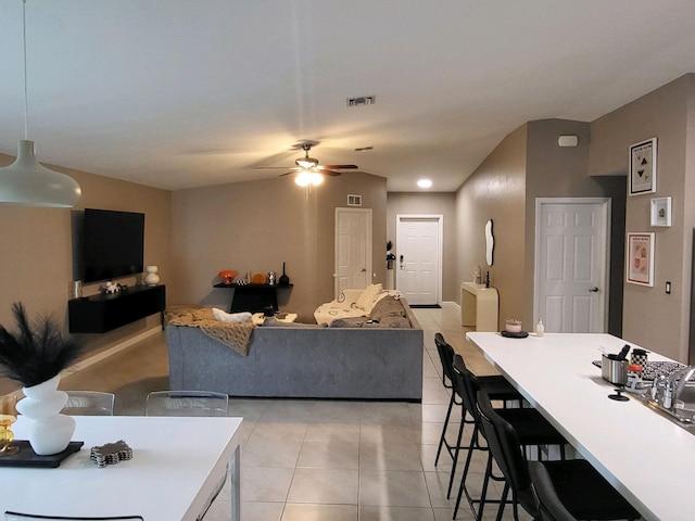 tiled living room with ceiling fan