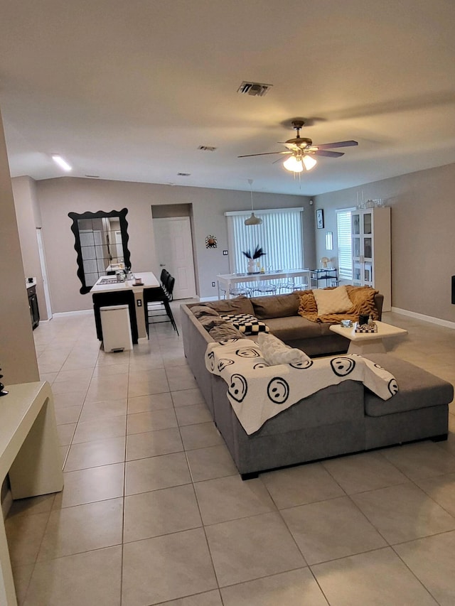 living room featuring light tile patterned flooring and ceiling fan