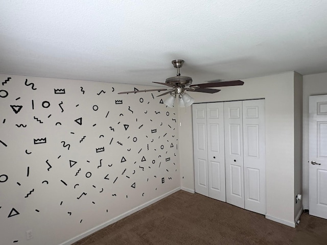 unfurnished bedroom featuring ceiling fan, a textured ceiling, carpet flooring, and a closet