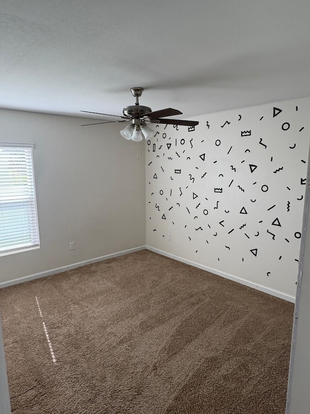 empty room featuring carpet floors and ceiling fan