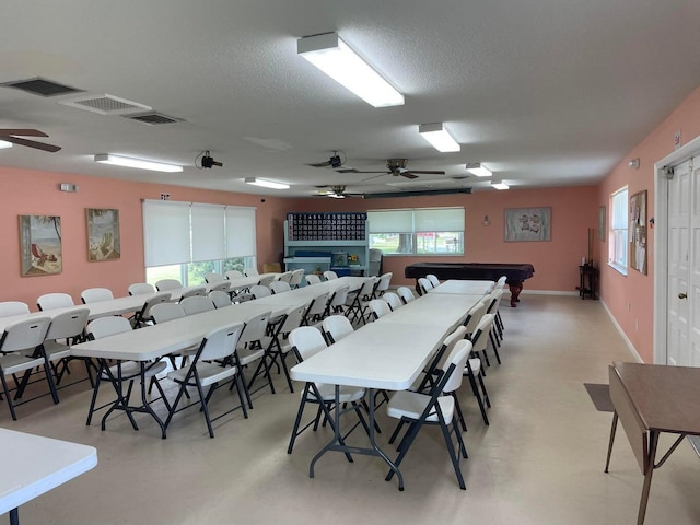 dining area featuring visible vents, ceiling fan, and a textured ceiling