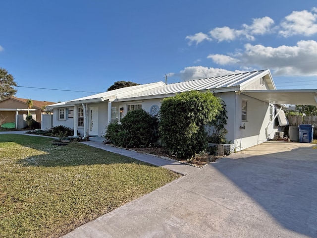 ranch-style home with a front lawn and a carport