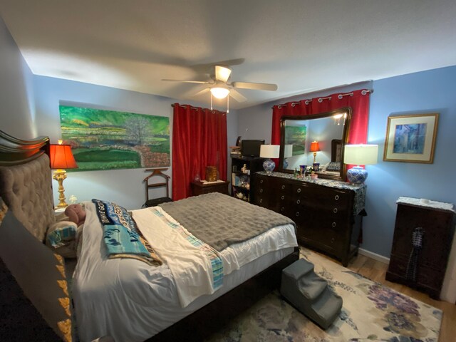 bedroom with ceiling fan and light hardwood / wood-style floors