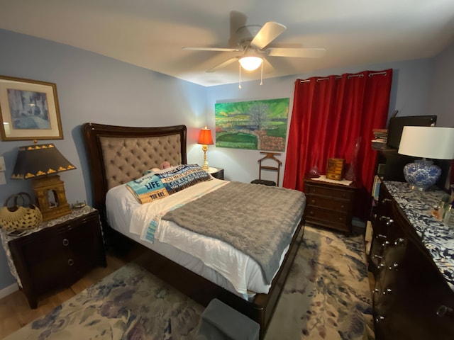 bedroom featuring ceiling fan and dark hardwood / wood-style floors