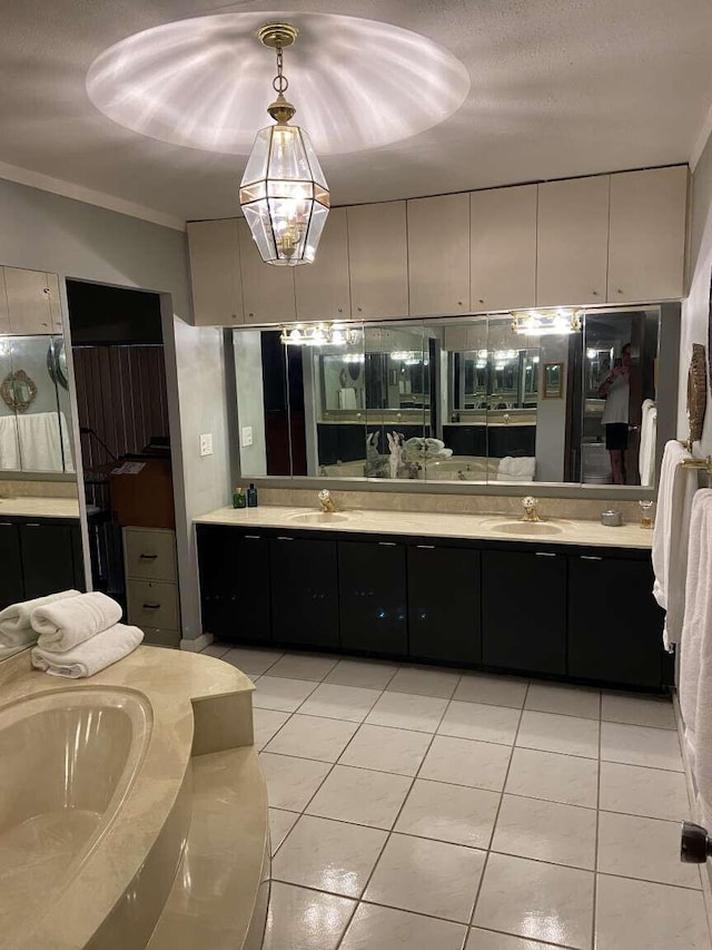 bathroom featuring ornamental molding, vanity, a textured ceiling, and tile patterned floors