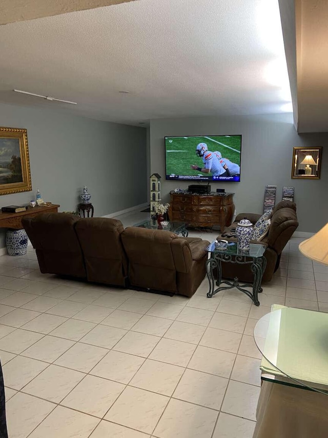 living room featuring a textured ceiling and light tile patterned floors