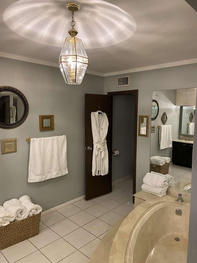 bathroom featuring ornamental molding, vanity, a tub to relax in, and tile patterned floors