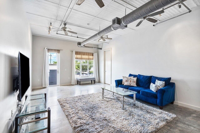 living room with concrete floors and ceiling fan