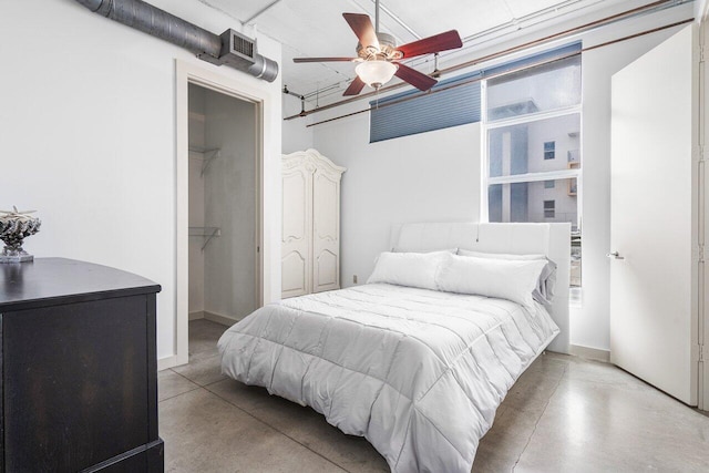 bedroom with ceiling fan, a closet, and a spacious closet