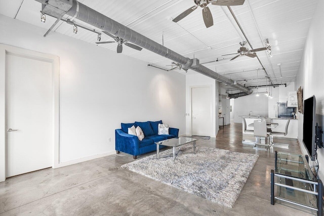 living room with ceiling fan and concrete floors