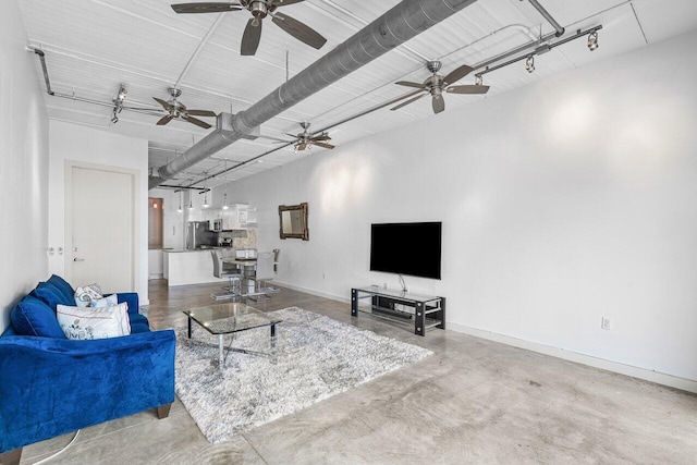 living room with concrete floors and ceiling fan