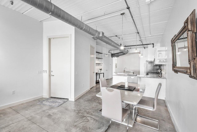 dining area featuring concrete floors and sink