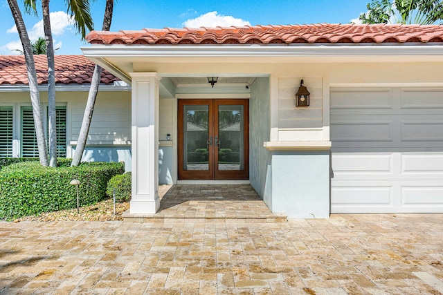 entrance to property featuring french doors and a garage