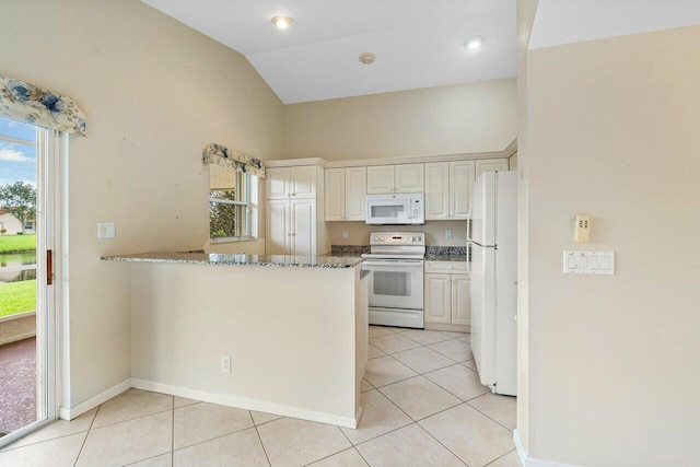 kitchen with white appliances, light tile patterned flooring, and a healthy amount of sunlight