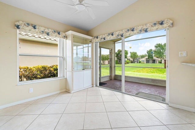 unfurnished sunroom with ceiling fan and vaulted ceiling