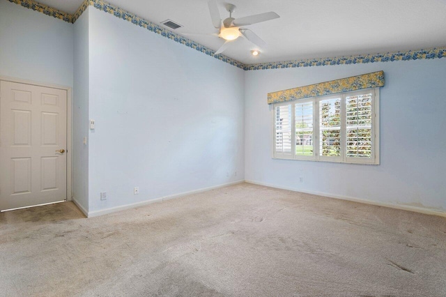 unfurnished room featuring ceiling fan, vaulted ceiling, and carpet floors