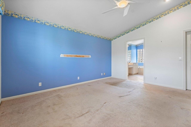 unfurnished bedroom featuring ceiling fan, light carpet, and connected bathroom