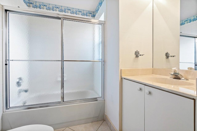 full bathroom featuring shower / bath combination with glass door, tile patterned flooring, toilet, and vanity