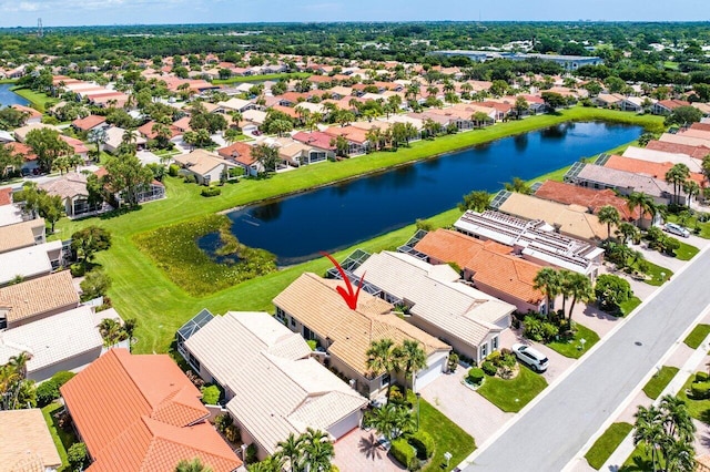 drone / aerial view featuring a water view and a residential view