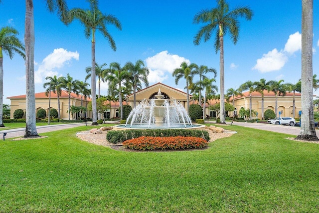 view of property's community with a lawn