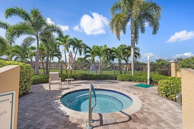 view of pool featuring a hot tub and a patio area