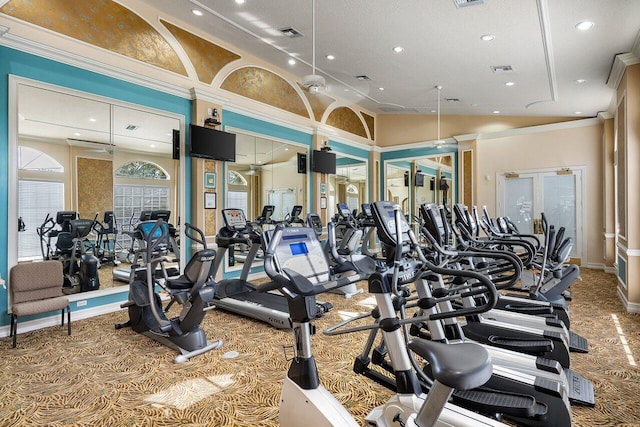 gym featuring carpet, vaulted ceiling, a textured ceiling, and ornamental molding