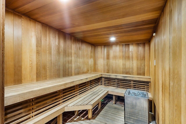 view of sauna / steam room with wood walls and hardwood / wood-style flooring