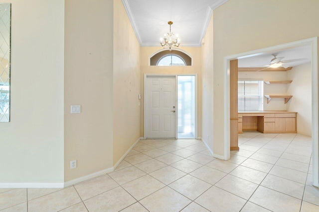 tiled foyer featuring crown molding and ceiling fan with notable chandelier