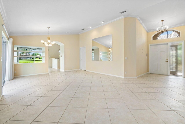 tiled foyer featuring crown molding, lofted ceiling, and a chandelier