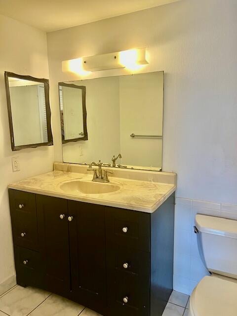 bathroom with vanity, toilet, and tile patterned floors