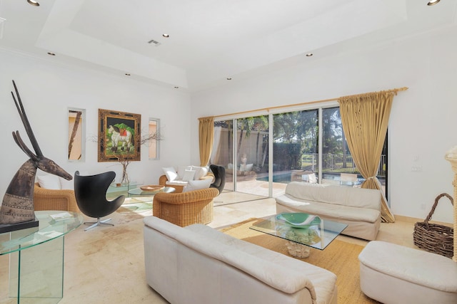 living room featuring recessed lighting, a raised ceiling, visible vents, and a high ceiling