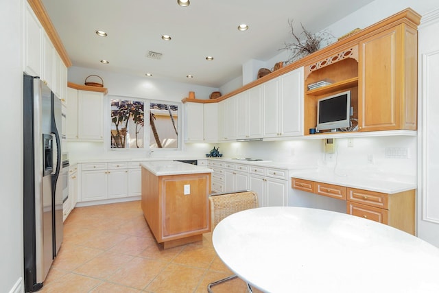 kitchen featuring light tile patterned floors, recessed lighting, visible vents, light countertops, and stainless steel fridge with ice dispenser