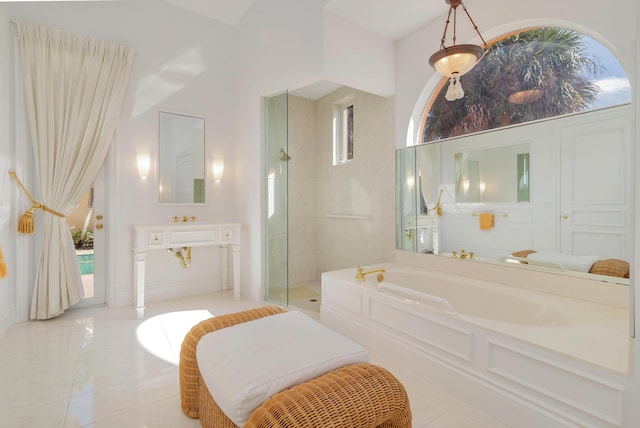 bathroom featuring tiled shower, vanity, a bath, and tile patterned floors