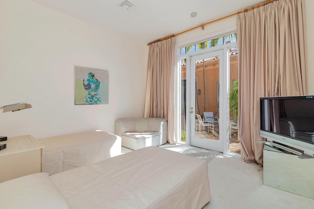 bedroom featuring access to exterior, carpet, and visible vents