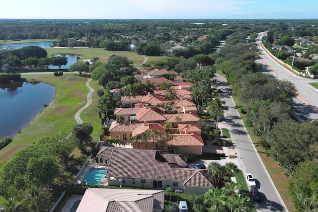 aerial view with a water view and view of golf course