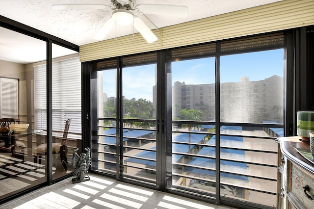 sunroom / solarium featuring ceiling fan