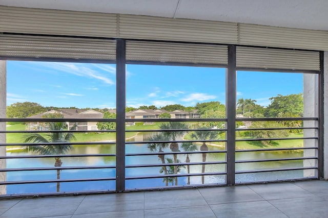 interior space featuring a water view and tile patterned flooring