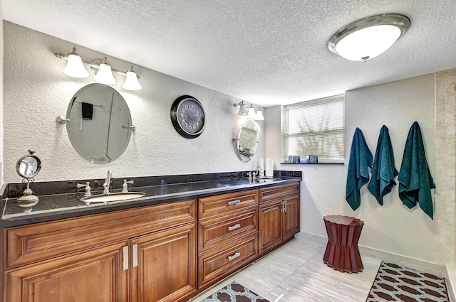 bathroom featuring a textured ceiling, vanity, and tile patterned flooring