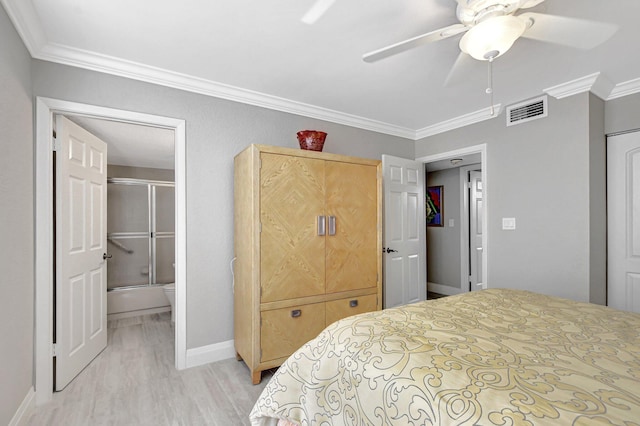 bedroom featuring crown molding, light wood-type flooring, ensuite bath, and ceiling fan