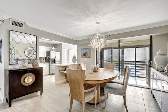 tiled dining space with ceiling fan with notable chandelier and ornamental molding