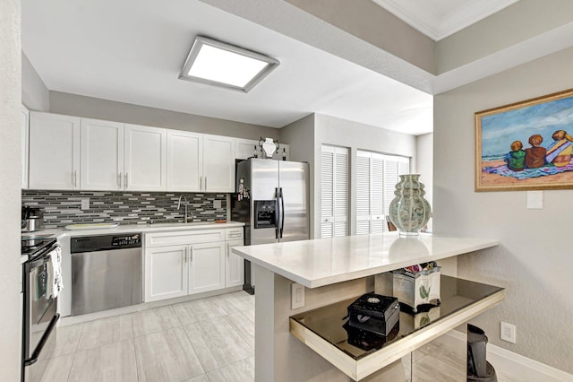 kitchen featuring white cabinets, appliances with stainless steel finishes, and backsplash