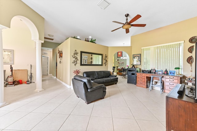 tiled living room featuring ceiling fan and ornate columns