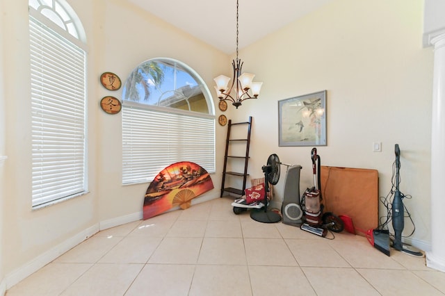 interior space with a chandelier, light tile patterned floors, vaulted ceiling, and decorative columns