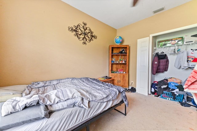 bedroom featuring ceiling fan, vaulted ceiling, and carpet