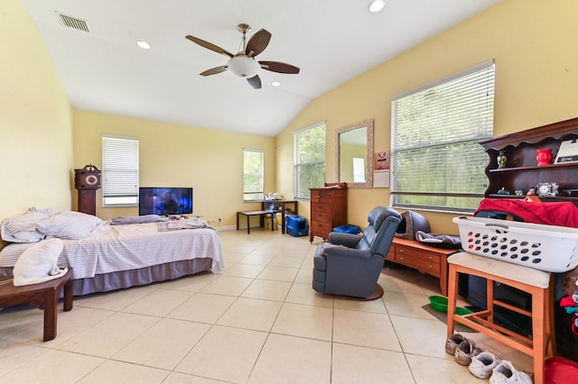 bedroom featuring multiple windows, vaulted ceiling, light tile patterned floors, and ceiling fan