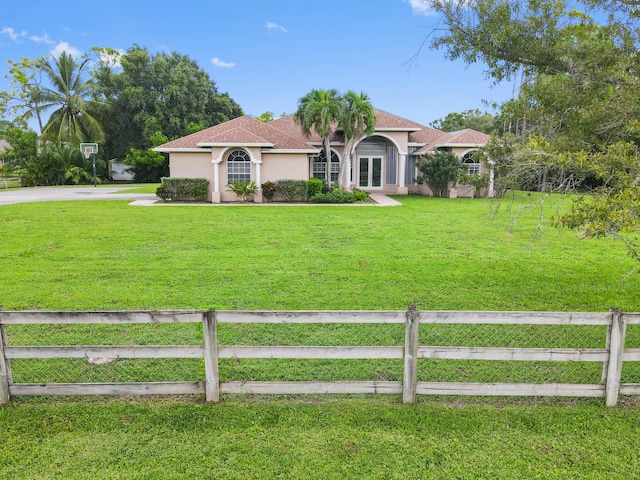 mediterranean / spanish house featuring a front yard